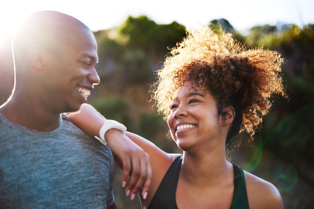 Close up of a male and female athletes smiling looking at each other 
