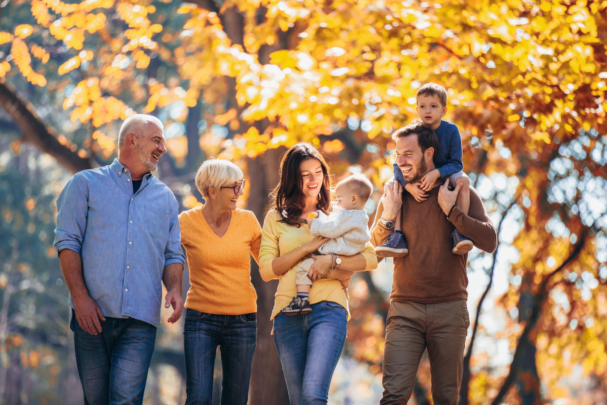 Family with parents and grandchildren on a walk in a park